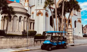 The electric golf cart that Panda Tours uses parked in front of the Memorial Presbyterian Church