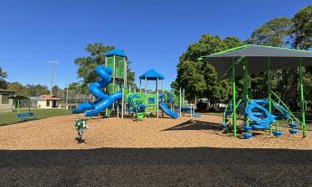 The playground has shaded areas and various structures for games
