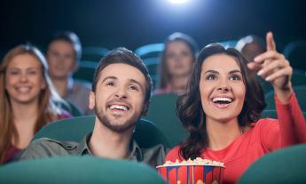 People watching a movie while enjoying a bucket of popcorn