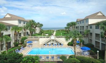 Four Winds Condominiums features beach access and oceanfront views.