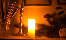 A candle set on a table in an old museum