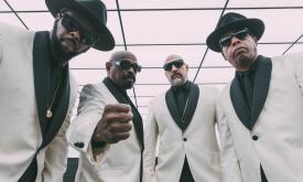 Bandmates from Cypress Hill don white and black suits and pose for fans. 