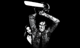 Ash Williams is covered in blood and lifts a chainsaw above his head. 