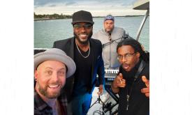 The band Chillula standing on a boat