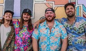 Hulagans band standing together, in hawaiian shirts