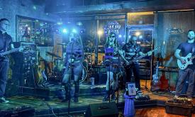 Tangled Orchid performing under blue lights