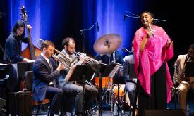 Samara Joy performing on stage with her band