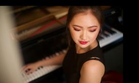Pianist Chelsea Wang at a keyboard, viewed from above