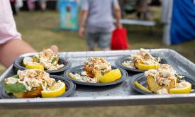 A tray with five crab open-faced sandwiches at the Lions Seafood Festival