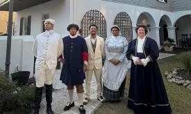 Five actors in historic dress outide the Peña-Peck House in St. Augustine