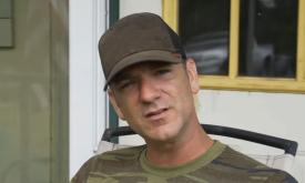 Songwriter Craig Campbell in brown ballcap, on a porch