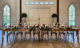 The head table settings at Chandler Oaks Barn wedding venue in St. Augustine, FL.