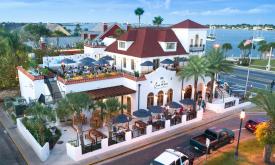 Casa Reina Taqueria & Taquila on the bayfront in St. Augustine is a regal white building with a red roof and outside dining spaces.