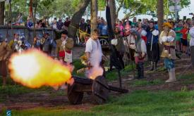 Groups of reenactors fire cannon during Drake's Raid in St. Augustine.