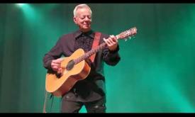 Tommy Emmanuel plays the guitar. 