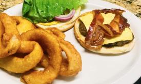Cafe Genovese lunch with a bacon cheeseburger and onion rings in St. Augustine.