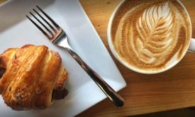 A croissant and a cup of coffee from Twisted Compass Brewing Co. 
