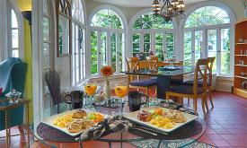 The high arched windows fill the dining room with light at the Casa de Sueños Bed & Breakfast in St. Augustine.