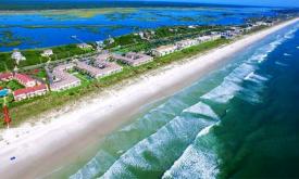 Four Winds Condominiums features beach access and oceanfront views.
