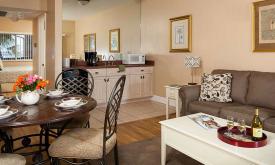 The suite's living space features a kitchenette and comfortable dining area.