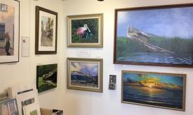 A corner featuring photographs and paintings at the Aviles Gallery in St. Augustine.