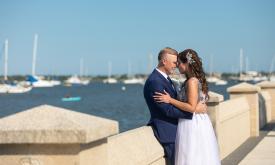 A bridal couple photographed on the waterfront across from Bayfront Marin House Weddings in St. Augustine. Photograph by Monarch Studio.
