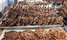 Caramel clusters line a case at Savannah Sweets.