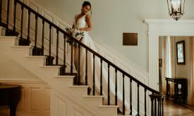 A bride on the stairs of Flagler College's Markland House in St. Augustine. Daybreak Photo.