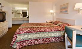A queen bed in a room at the Ramada Limited in St. Augustine.