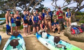 A large group of kayakers gather ashore on a trip with Kayaking St. Augustine.