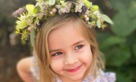A flower girl wearing a wreath created by The Potting Shed in St. Augustine.