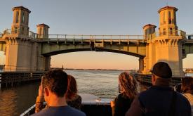 Guests standing on the bow of Sabrage as she heads under the Bridge of Lions in St. Augustine.