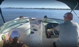A family enjoying the water on a boat from Summer Breeze Boar Rental in St. Augustine.