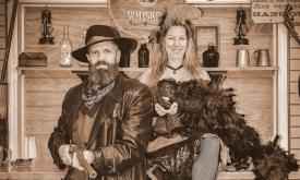 Man and a woman dressed as saloon girl and cowboy