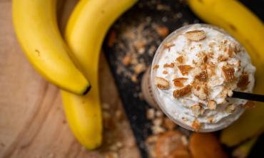 Ellianos cold coffee with whipped cream and banana bread sprinkled on the top. 