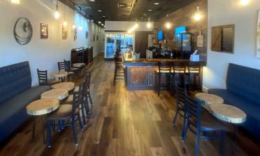 The bar and tables in the relaxing interior of Southern Vibes Tasting Room and Wine Cellar at Murabella Crossing in St. Augustine.