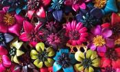 Leather handcrafted flower pins made by a family in Thailand on display at Crafts Without Borders in St. Augustine.