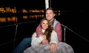 A couple enjoying a private Nights of Lights cruise aboard a sailboat from St. Augustine Sailing.