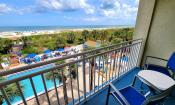 A view of the sundeck, pool, and beach from an Oceanfront Guest Room at Guy Harvey Resort St. Augustine.
