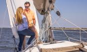 A couple stand on deck aboard a St. Augustine Sailing Charter in Matanzas Bay.