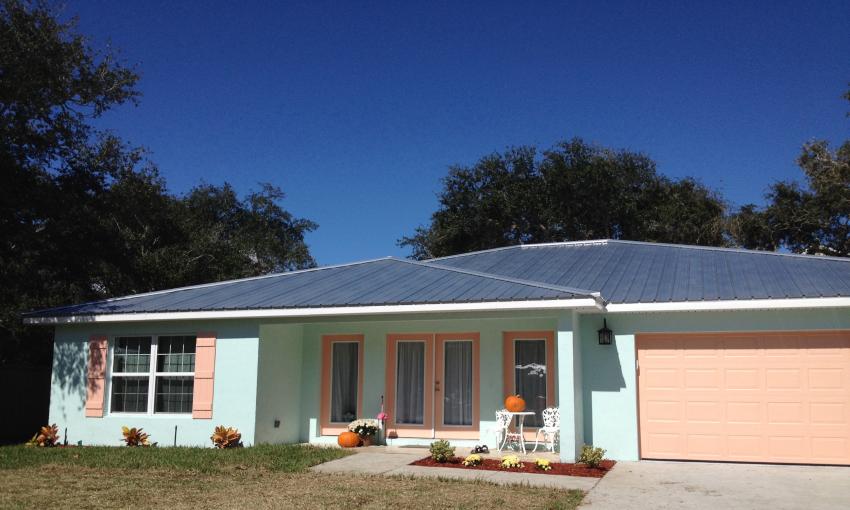 Small ranch houses, such as this one in Caribbean colors, sit in small neighborhoods in Vilano