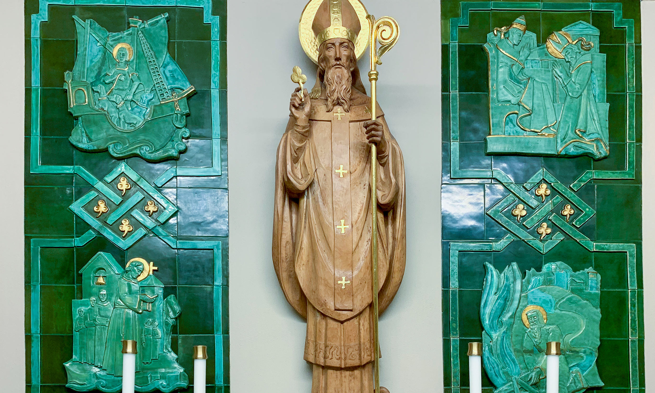 A close-up of the chapel of Saint Patrick in the Cathedral Basilica of Saint Augustine in St. Augustine, Florida. This chapel is a nod to the Irish history of the Cathedral Basilica, which has had many Irish bishops throughout its history. The hand-carved wooden sculpture of St. Patrick is backed by green-stone scenes that depict scenes from the saint’s life.